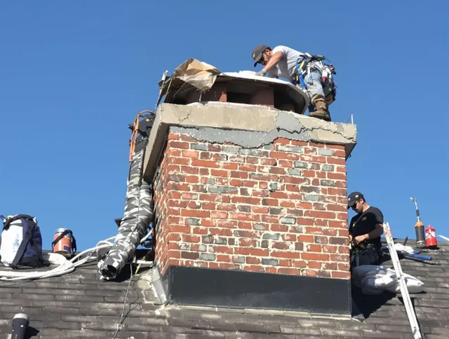 Wayland Chimney Sweep installing a custom chimney crown in Wayland, MA