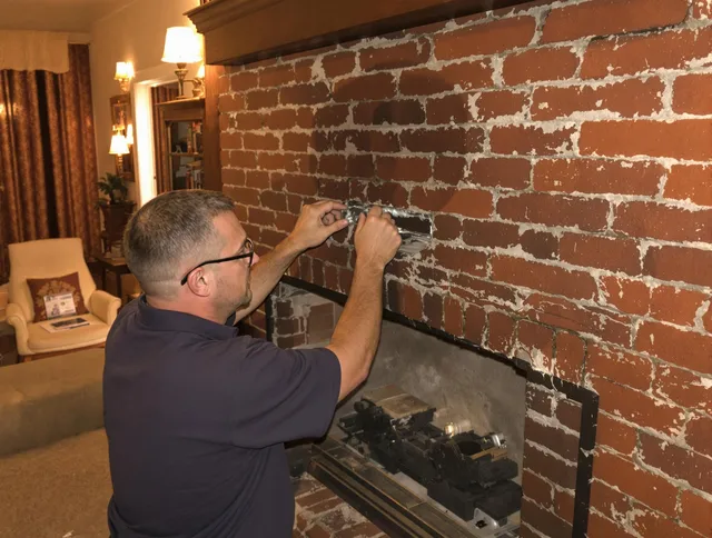 Wayland Chimney Sweep expert fixing a fireplace in Wayland, MA